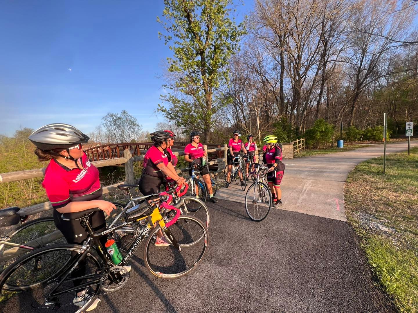 Biciescuela participants riding in a protected bike lane